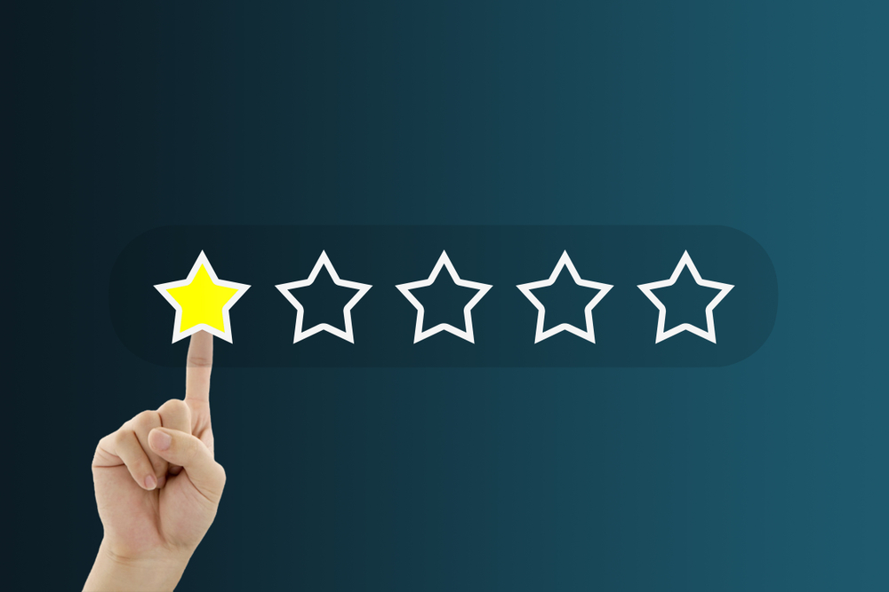 Customer Feedback Concept : Hand pressing one yellow star for giving best service ranking.