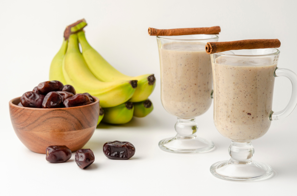 Glasses of date milkshake with cinnamon and spice