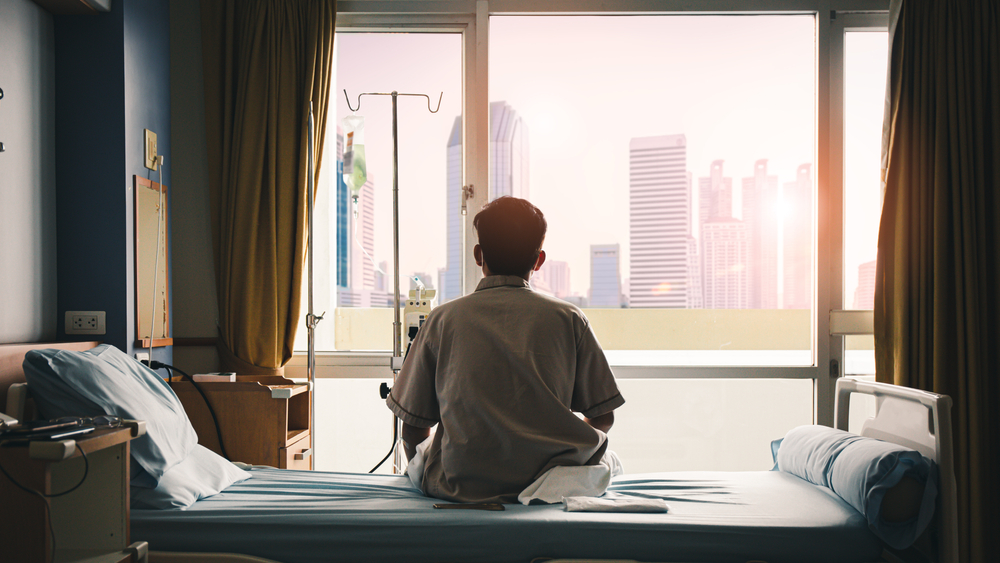 patient sat on the bed and looked out the window in the hospital alone and had stress, boredom, loneliness, anxiety. / Health care and medical

