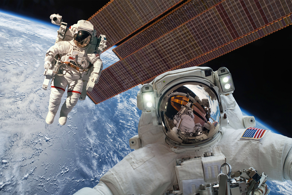 International Space Station and astronaut in outer space over the planet Earth. Elements of this image furnished by NASA.