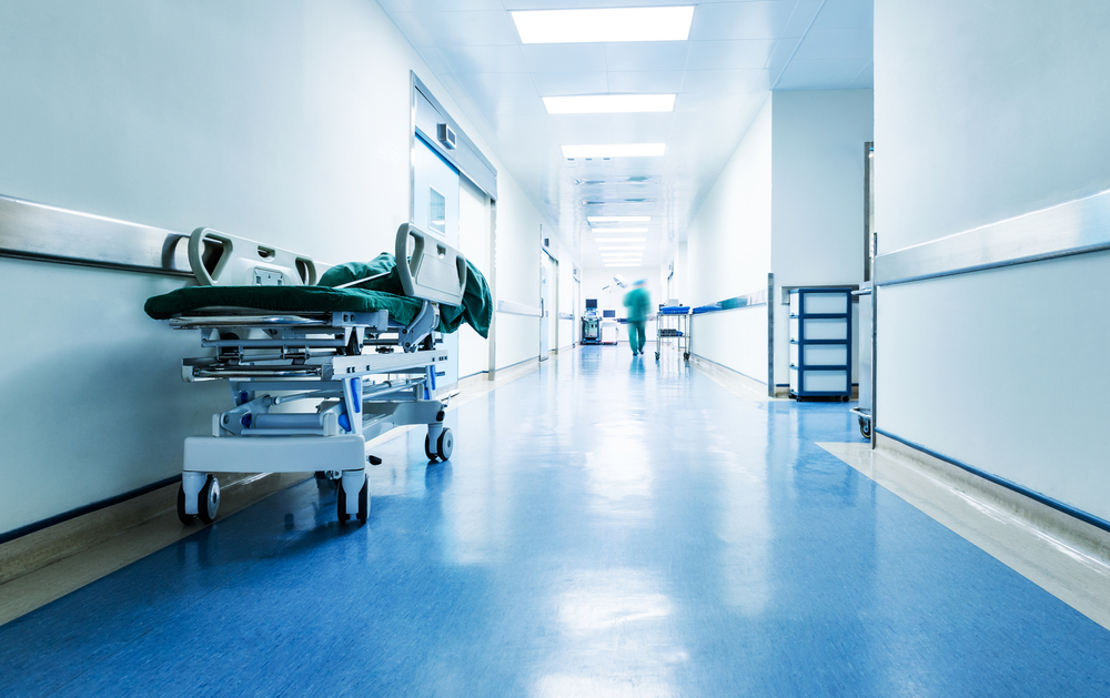 Doctors or nurses walking in hospital hallway, blurred motion.