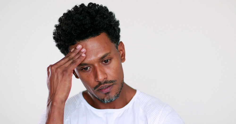 Anxious African man telling viewer to hurry up, showing anxiety emotion