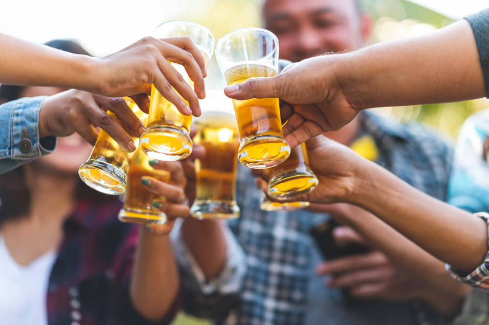 Group of happy friends living healthy lifestyle and relax Cheering with beer and And Drinking Beer
