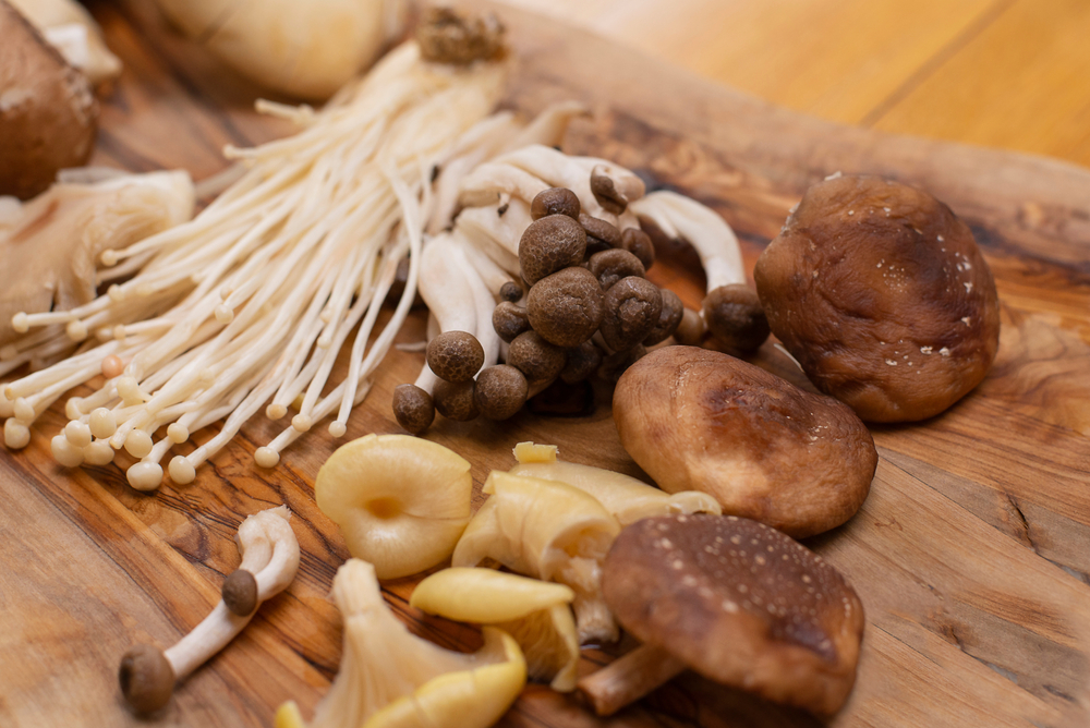 Wild Foraged Mushroom selection on wooden background.
