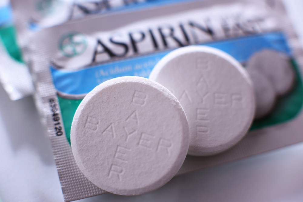 POZNAN, POL - FEB 17, 2021: Aspirin pills, a brand of popular medication, the first and best-known product of Bayer, German multinational pharmaceutical company headquartered in Leverkusen