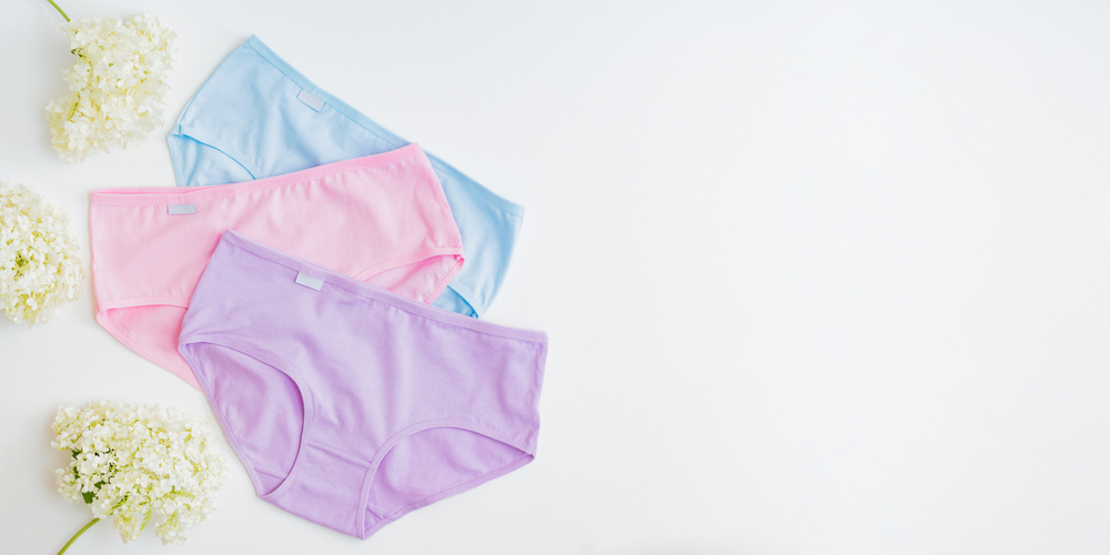 Flat lay set of women panties of different colors on a white background. Top view advertising and shopping concept