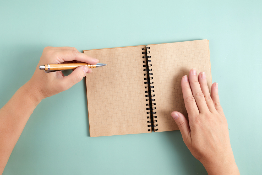 Happy Left Hander's Day. Left hand hold pen and writing text.