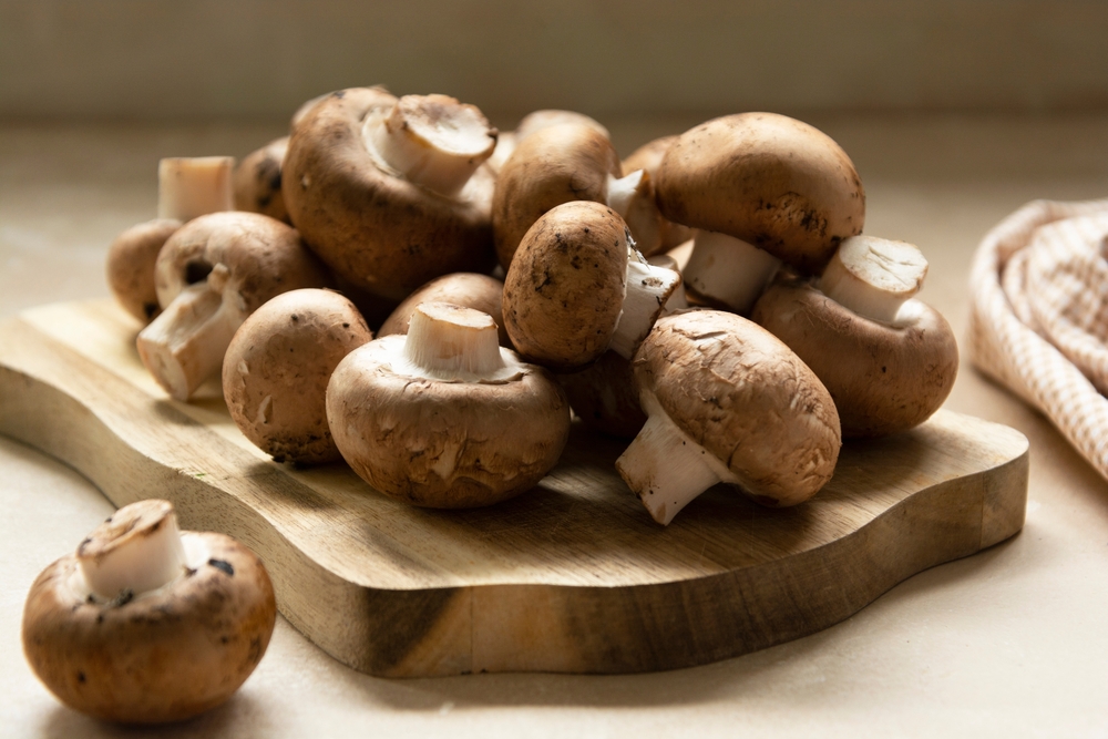 Champignons fresh mushrooms on cutting board
