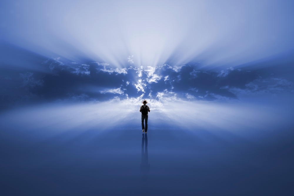 Man walking alone towards the light