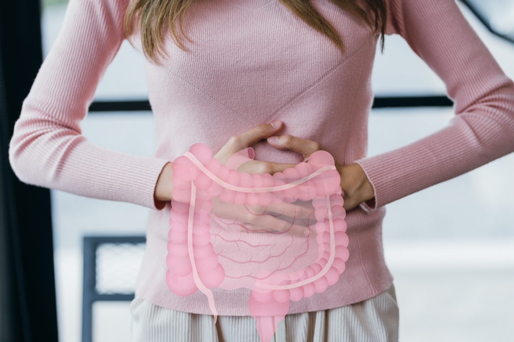 woman hands touching on stomach with intestine virtual icon, probiotics food for gut health, colon cancer, bowel inflammatory. Healthy feminine concept.
