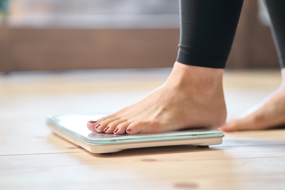 Feet of an Asian woman on a weight scale
