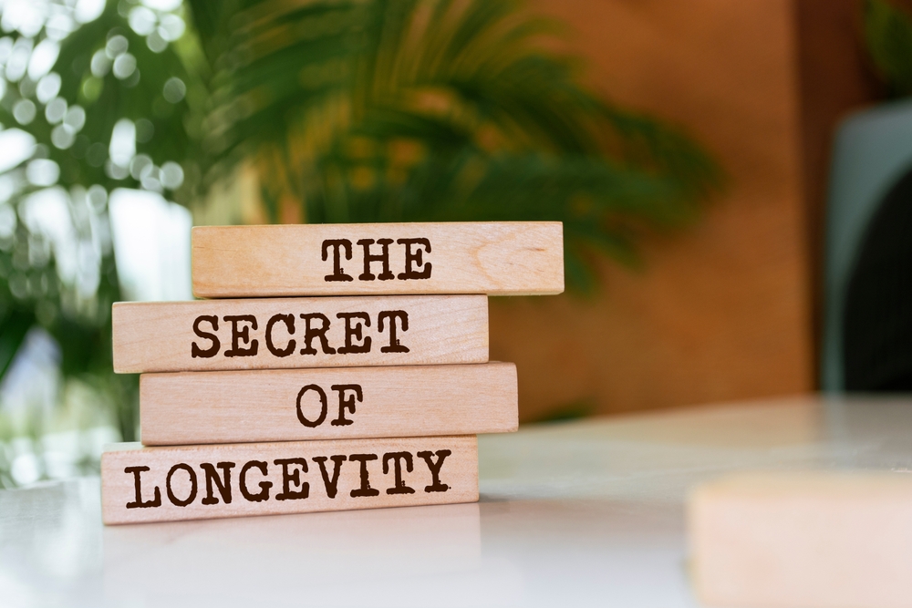 Wooden blocks with words 'The secret of longevity'.
