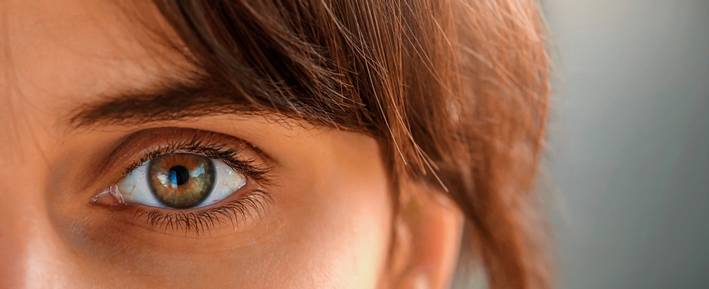 Close up of egreen eye of beautiful young woman. Tired eyes and contact lenses. Close up. Dry eye before and after the use of eye drop.