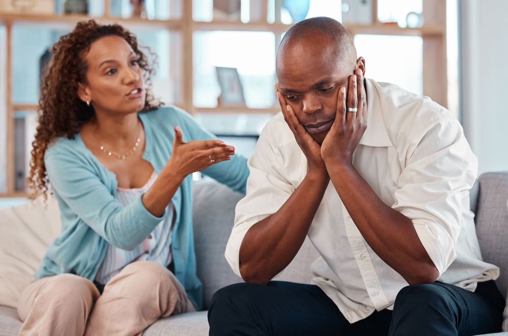 Couple, fight and angry on sofa for marriage problems, conflict and bad communication. Divorce, argument and frustrated people in anger with man, woman and partner in living room for blame of affair
