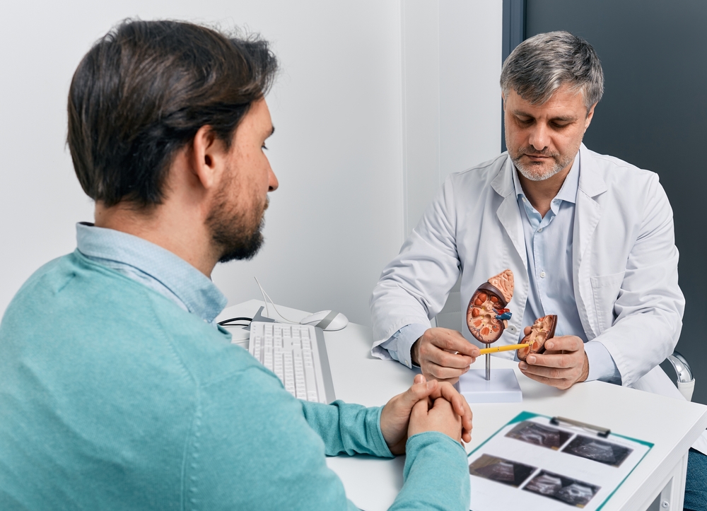 Adult man during consultation with experienced urologist about his kidney disease and treatment at medical clinic. Kidneys health
