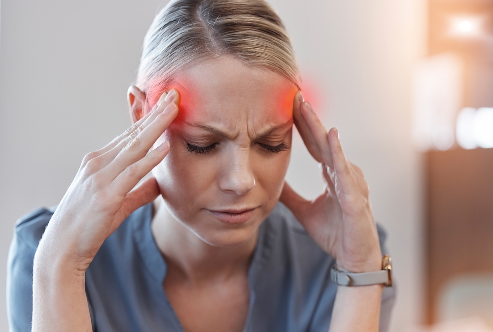 Business woman, headache and stress with thinking, red glow or overlay for burnout at finance job. Accountant employee, pain and tired with fail, depressed and fatigue with pressure at modern office
