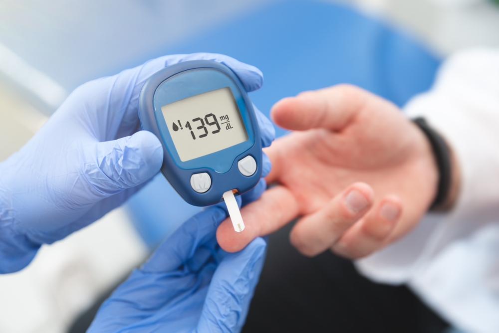 Doctor using glucometer, blood glucose test. Diabetes concept