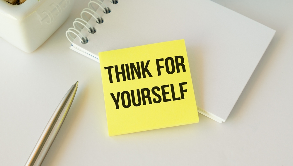 Think For Yourself text on a white paper. the inscription on the notebook
