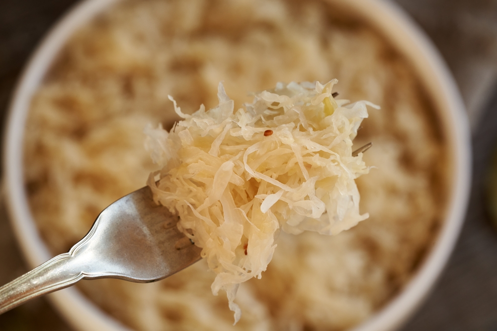 Homemade fermented cabbage or sauerkraut on a fork, top view