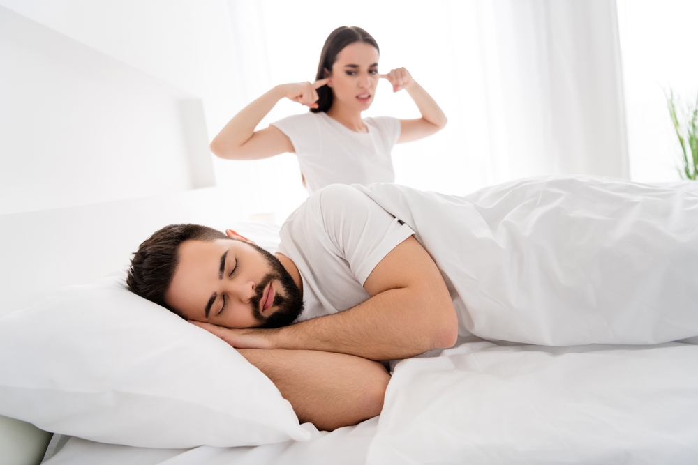 Photo of two people couple man sleeping girl cover ears annoyed with snoring in white house