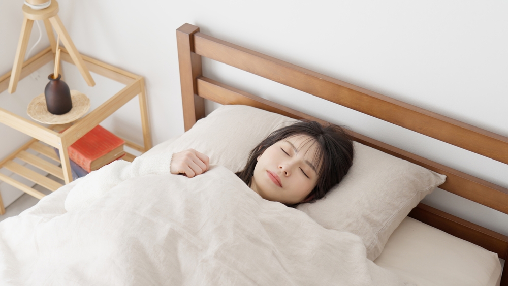 Asian woman sleeping in bed