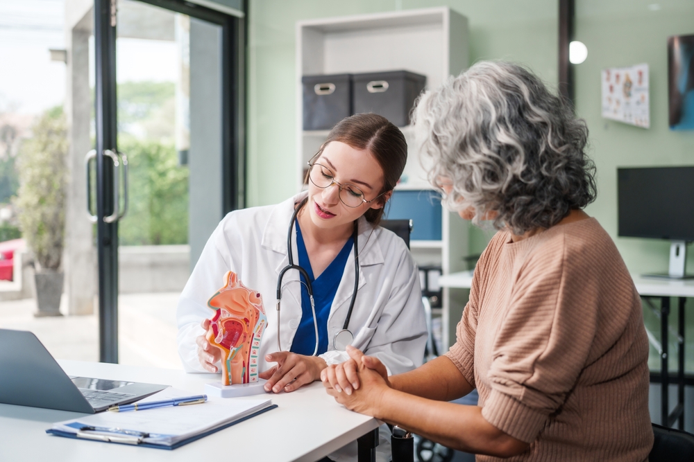 Caucasian woman and elderly Asian woman discuss health issues cold, influenza, pneumonia, bronchitis, stomach disease, GERD, IBS, inflammatory bowel disease, gallstones, chronic constipation