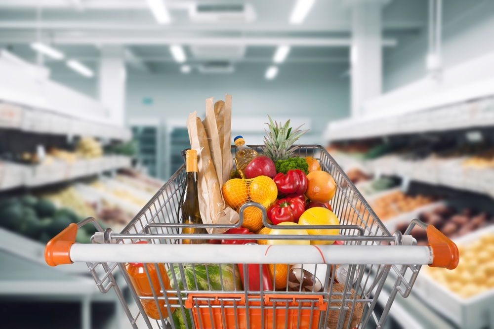 customer buying food groceries at the supermarket with shopping cart