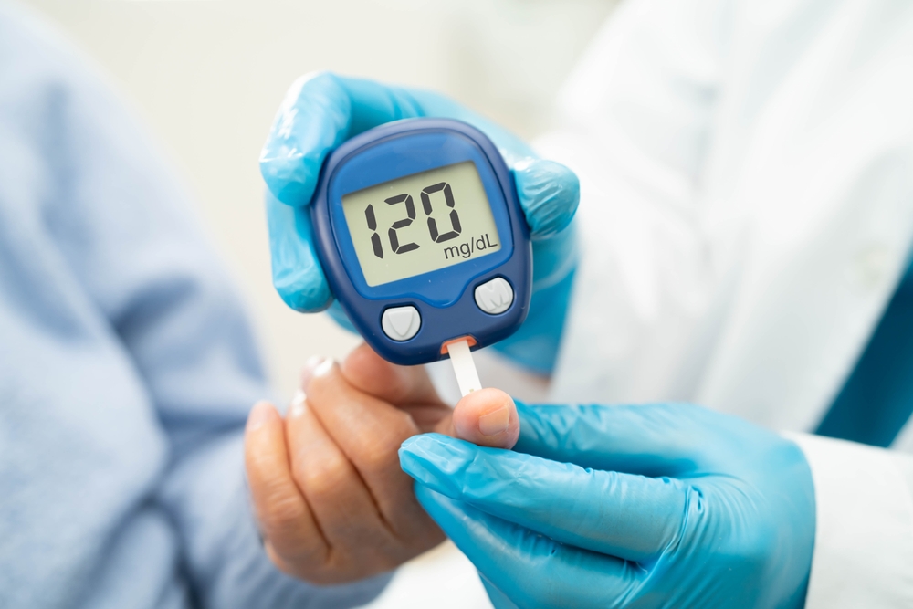 Doctor use digital glucose monitor measure and test stripe for check diabetes from finger blood sugar level.