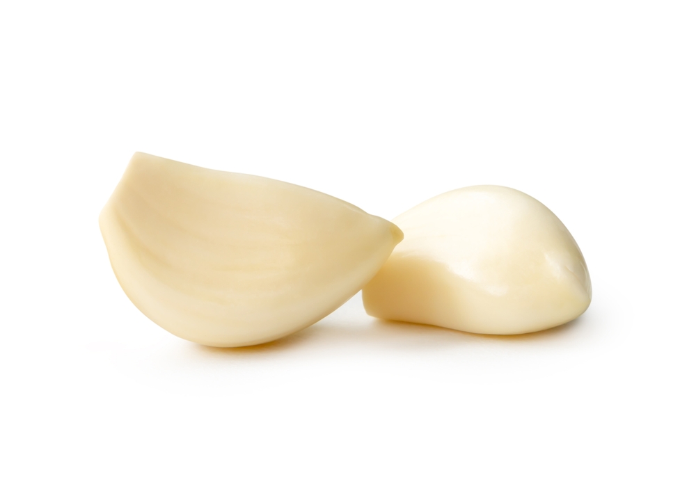 Front view of white peeled garlic cloves is isolated on white background with clipping path.
