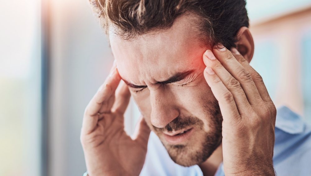 Headache, man and massage temple with pain for dizziness, tired or stress on moving day. Red overlay, fatigue and male person with migraine for brain fog, health emergency or burnout in home