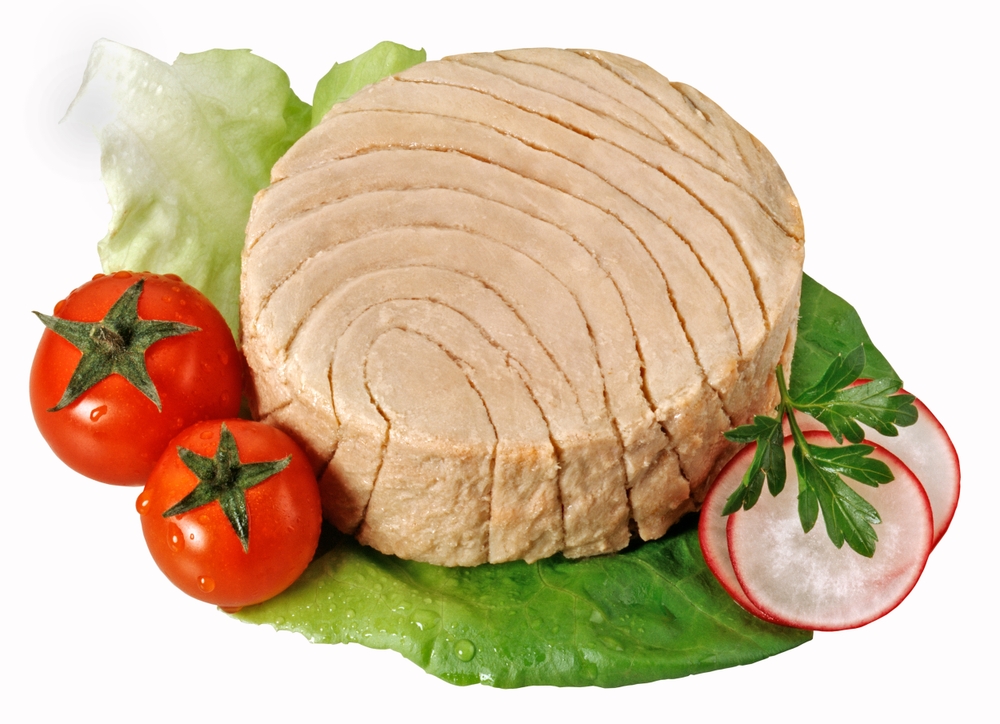 Canned tuna portion on a lettuce leaf with cherry tomatoes and thin slices of radish isolated on white background,accurate clipping path embedded.