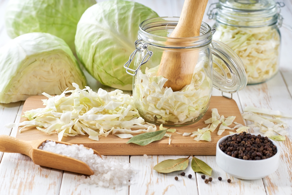 preparation for making sauerkraut or fermented white cabbage: white cabbage, caraway seeds, black pepper, salt, bay leaves. Food fermentation. Fermented preserved vegetarian food.