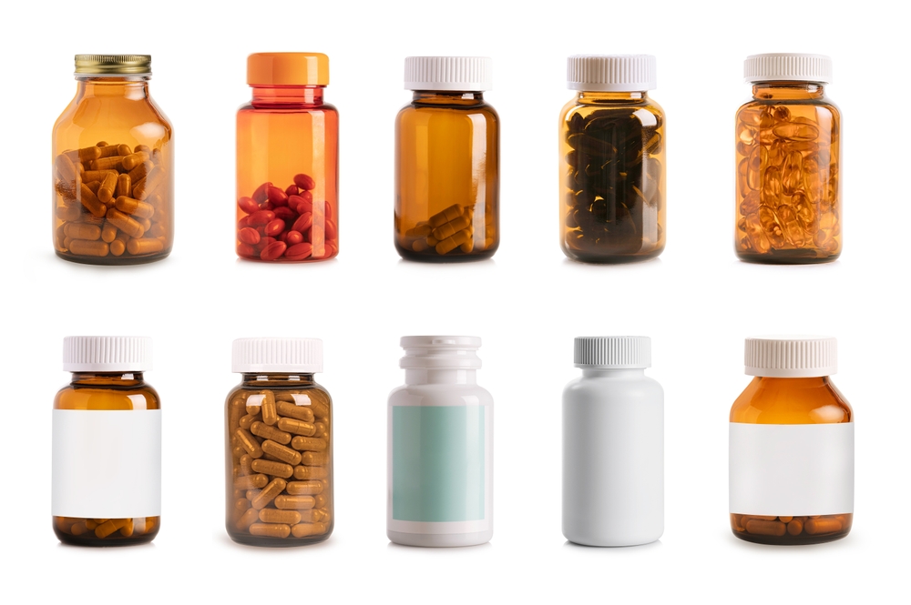 Collection of supplement bottles isolated on white background.