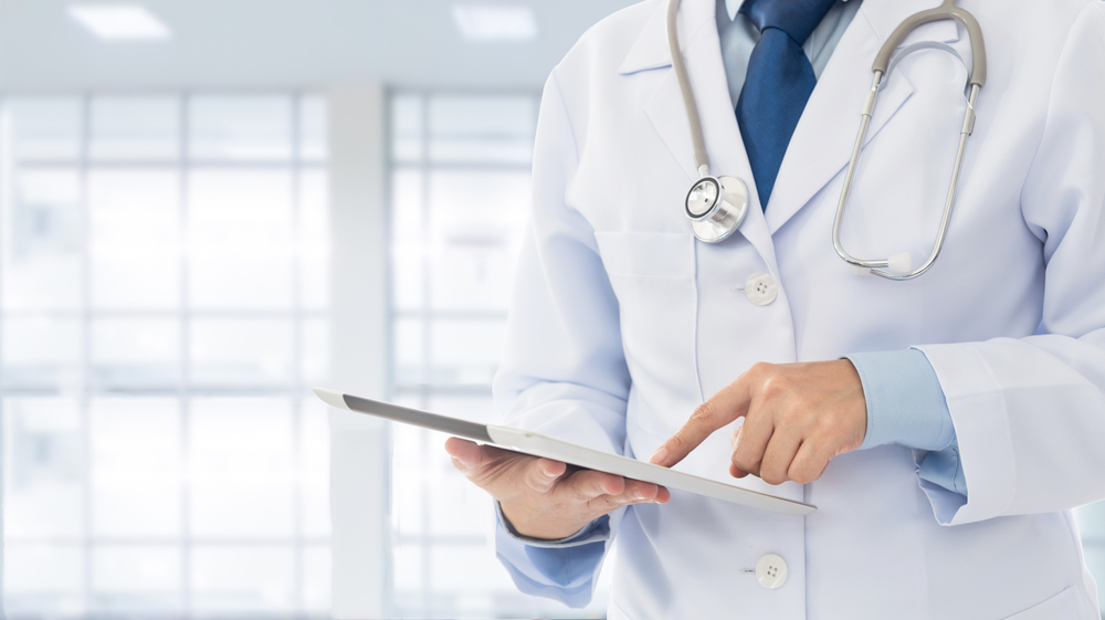 Doctor using digital tablet find information patient medical history at the hospital. Medical technology concept.