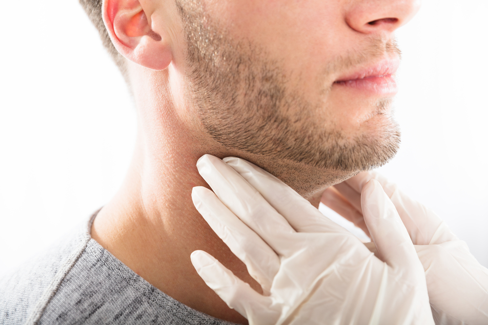 Doctor Performing Physical Exam Palpation Of The Thyroid Gland