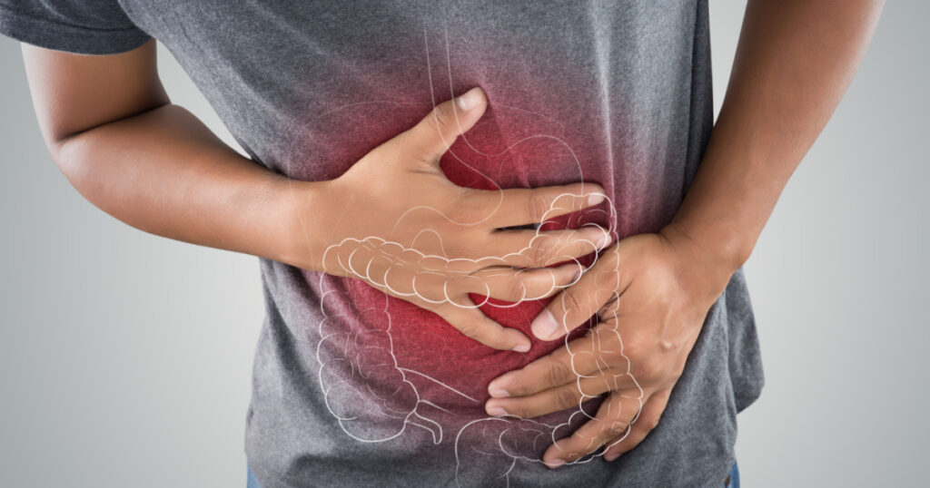The photo of large intestine is on the man's body against gray background, People With Stomach ache problem concept, Male anatomy