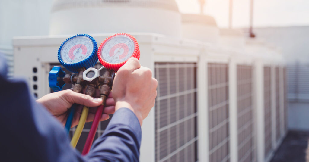 Technician is checking air conditioner ,measuring equipment for filling air conditioners.