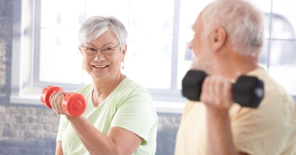 Vital senior couple exercising in the gym.