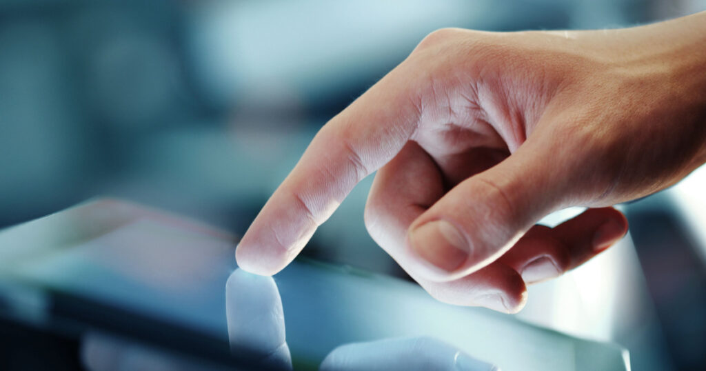 hand presses on screen digital tablet