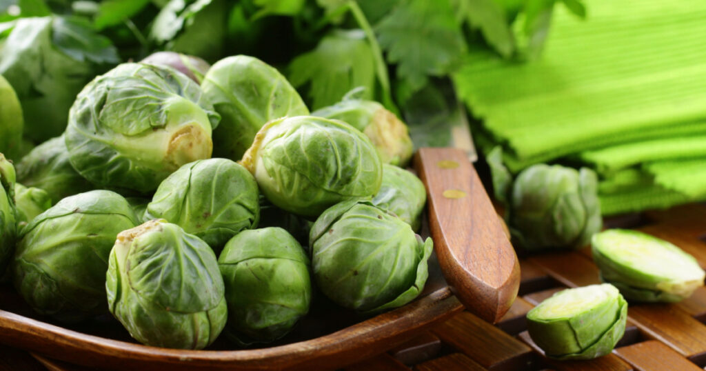 fresh raw brussels sprouts on a wooden table