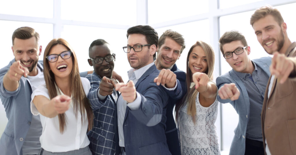 group of successful young men pointing at you