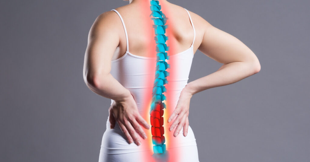 Pain in the spine, woman with backache on gray background, back injury, photo with highlighted skeleton