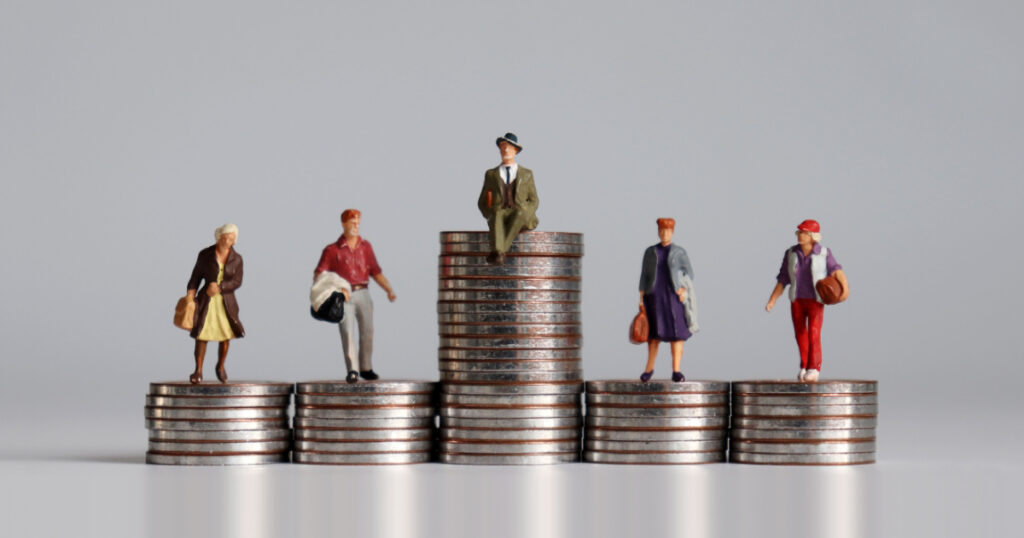 ocial stratification concept. Miniature people with stack of coins.