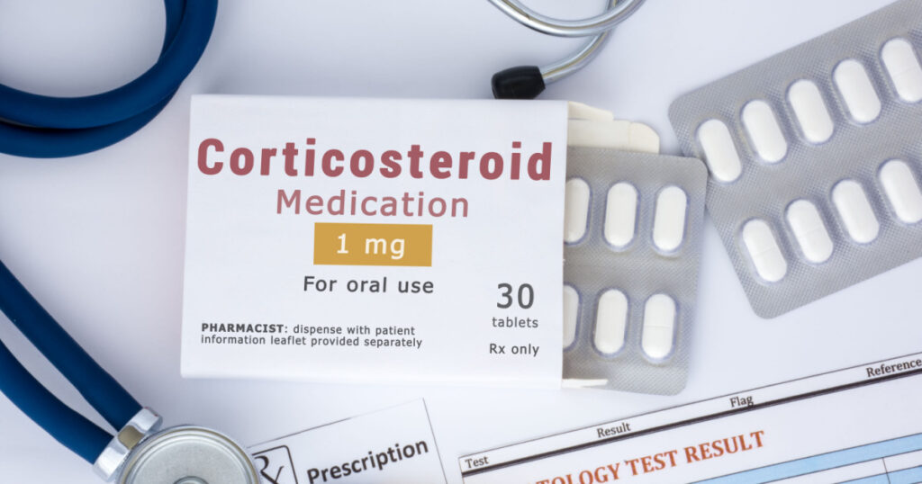 KYIV, UKRAINE-APRIL 22, 2019: Corticosteroid medication or drug concept photo. On doctor table lies open packaging labeled "Corticosteroid medication" and fell out of blisters with pills treatment