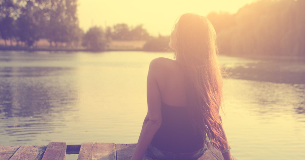 Vintage photo of relaxing young woman in nature