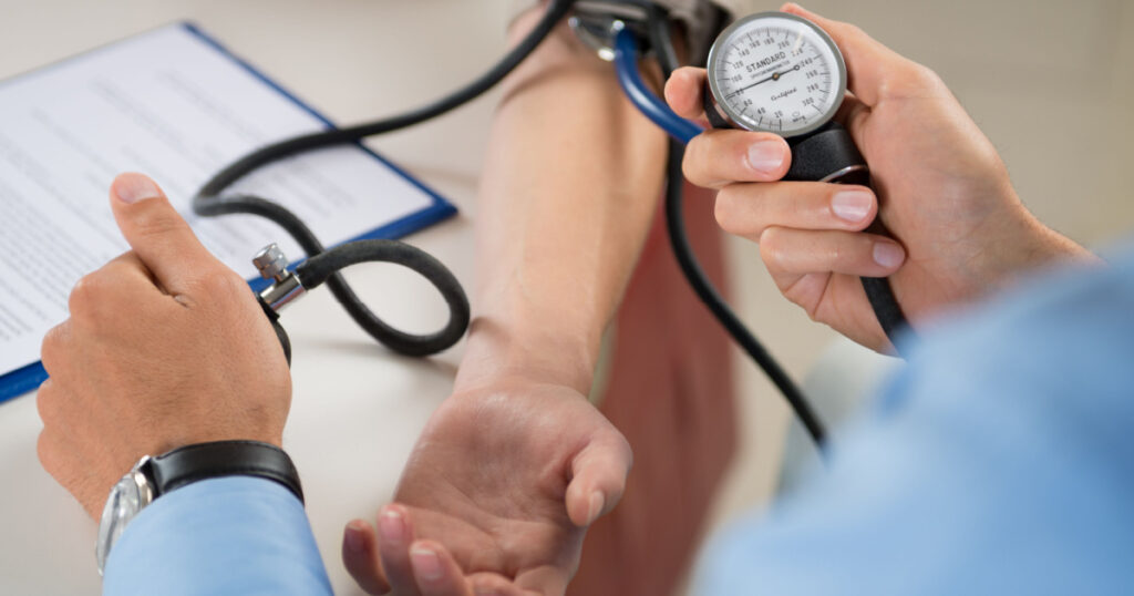 Close Up Of A Doctor Checking Blood Pressure Of A Patient