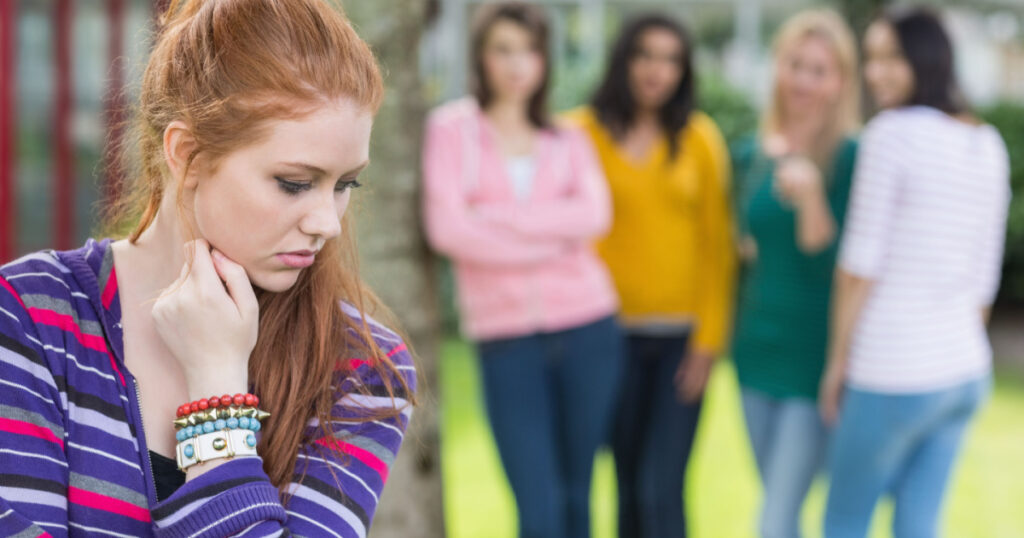 Female student being bullied by other group of students