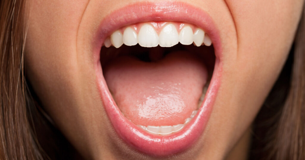 A young pretty woman teeth extreme closeup photo