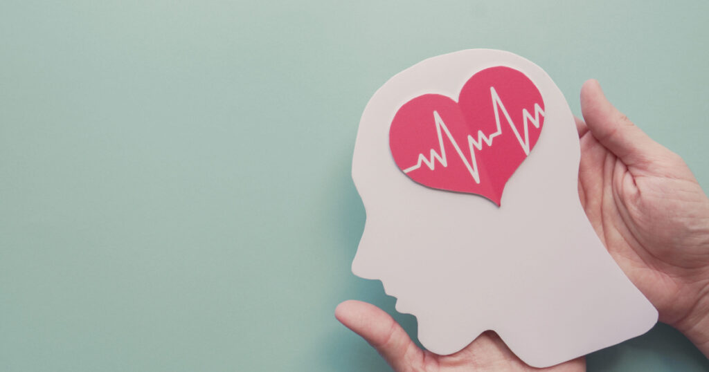 Hands holding paper brain and heart, brain stroke, world heart day, world mental health day, Alzheimer and wellness concept