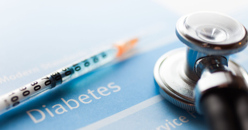 Stethoscope and a syringe on a diabetes test
